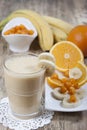 Smoothie of banana, orange juice , frozen sea-buckthorn with y Royalty Free Stock Photo