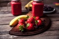 Smoothie with banana and strawberry in the glass, fresh strawberries and bananas on the old wooden background Royalty Free Stock Photo