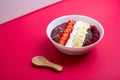 Smoothie bowl or acai berry bowl with chia, strawberries, raspberries, banana slices and coconut flakes. Top view. Royalty Free Stock Photo