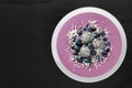 Smoothie bowl with blueberries, dragon fruit, coconut, on slate Royalty Free Stock Photo