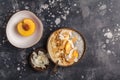Smoothie bowl with chia pudding, peach, coconut and granola in a