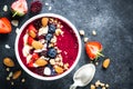 Smoothie bowl from fresh berries, nuts and granola. Royalty Free Stock Photo