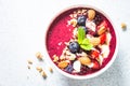 Smoothie bowl from fresh berries, nuts and granola. Royalty Free Stock Photo