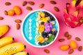 Smoothie bowl with fruits, berries, nuts and flowers. Tropical healthy smoothie dessert. Healthy breakfast, vegetarian food, lunch Royalty Free Stock Photo