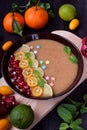 Smoothie bowl garnished with kumquats, pomegranate, lime and mint Royalty Free Stock Photo