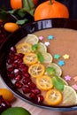 Smoothie bowl garnished with kumquats, pomegranate, lime and mint Royalty Free Stock Photo