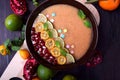 Smoothie bowl garnished with kumquats, pomegranate, lime and mint Royalty Free Stock Photo
