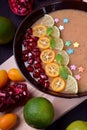 Smoothie bowl garnished with kumquats, pomegranate, lime and mint Royalty Free Stock Photo