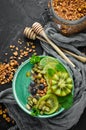  bowl with green spirulina, kiwi, mint and pumpkin seeds. Breakfast. Top view.