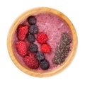 Smoothie bowl isolated on white background. Delicious pink berry smoothie topped with raspberry, blackberry and chia seeds.