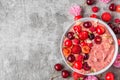 Smoothie bowl or nice cream made of frozen bananas and berries with fresh berries, nuts and seeds. healthy breakfast Royalty Free Stock Photo