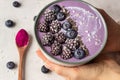 Smoothie bowl topped with blueberries, blackberries, chia seeds and coconut flakes. Royalty Free Stock Photo