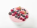 Smoothie bowl with yogurt, muesli and frozen berry. Pink yogurt smoothie bowl topped with frozen berries. Royalty Free Stock Photo