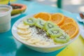 smoothie bowls garnished with fresh tropical fruit slices on a bright caf table