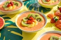 smoothie bowls garnished with fresh tropical fruit slices on a bright caf table