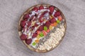 Smoothie in coconut bowl with raspberries, oatmeal, candied fruit and chia seeds for breakfast , close up. The concept of healthy Royalty Free Stock Photo