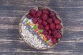 Smoothie in coconut bowl with raspberries, oatmeal, candied fruit and chia seeds for breakfast , close up. The concept of healthy Royalty Free Stock Photo