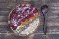 Smoothie in coconut bowl with raspberries, oatmeal, candied fruit and chia seeds for breakfast , close up. The concept of healthy Royalty Free Stock Photo