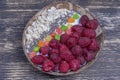 Smoothie in coconut bowl with raspberries, oatmeal, candied fruit and chia seeds for breakfast , close up. The concept of healthy Royalty Free Stock Photo