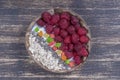 Smoothie in coconut bowl with raspberries, oatmeal, candied fruit and chia seeds for breakfast , close up. The concept of healthy Royalty Free Stock Photo