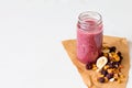 Smoothie of freeze-dried cherry, banana, apple, blueberry in a highball glass