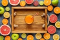 Smoothie or fresh juice in wooden tray in citrus fruits background flat lay, healthy lifestyle vegan organic antioxidant Royalty Free Stock Photo