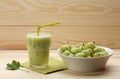 Smoothie from gooseberries in a glass and gooseberries in bowl Royalty Free Stock Photo