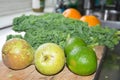 Smoothie ingredients kale pears lime oranges