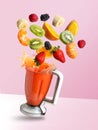 Smoothie mixer with drink and fruit flying ingredients