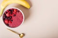 Smoothie surrounded by bananas, strawberries, and blueberries Royalty Free Stock Photo