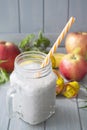 Smoothie of yogurt, nettle, apple, banana and herbs on a light table