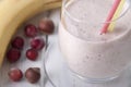 Smoothies with a banana, frozen gooseberry and hazelnut with yogurt in a glass