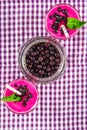 Smoothies of black currant in glass glasses with straws on a white wooden table. Top view. Royalty Free Stock Photo