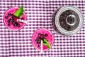 Smoothies of black currant in glass glasses with straws on a white wooden table. Top view. Royalty Free Stock Photo