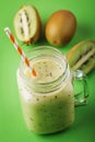 Smoothies cooked from ripe kiwi in a transparent jar