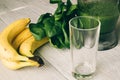 Smoothies in the food processor, empty glass, banana and spinach