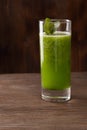 Smoothies green dietary vegetarian on a wooden table with mint l