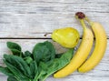 Healthy food. Smoothies and ingredients for detox, banana, pear, spinach leaves on a gray wooden background, top view, copy space