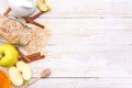 Smoothies with oatmeal, apple and cinnamon in glass jars on a wooden background.