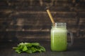 Smoothies from wild leek, honey and banana in a glass mug, close up