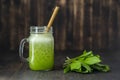 Smoothies from wild leek, honey and banana in a glass mug, close up