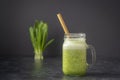 Smoothies from wild leek, honey and banana in a glass mug, close up