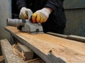 Smoothing the surface of a wooden log with a planer Royalty Free Stock Photo