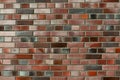 Smoothly flamed red-blue-colored Clinker brick wall and facade, facing brick glittering. Naturally burned shiny brick clinker text Royalty Free Stock Photo