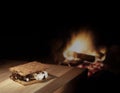 Smore that is homemade next to a campfire