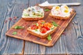 Smorrebrod - traditional Danish sandwiches. Black rye bread with fish, herring, egg, tomatoes, radish on dark brown wooden