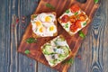 Smorrebrod - traditional Danish sandwiches. Black rye bread with fish, herring, egg, tomatoes, radish on dark brown wooden