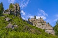 Smoth crag rocks, mountains with green spruces and fir trees on blue sky. Relaxing hiking nature landscape. Tustan, Ukraine Royalty Free Stock Photo