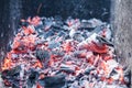 Smouldering coals at barbeque campfire