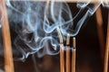 Smouldering incense sticks, burning and smoking